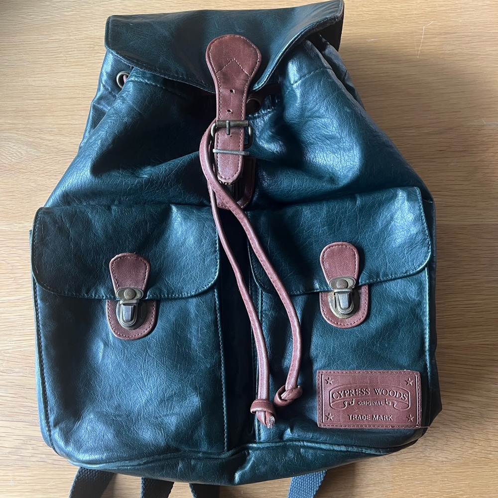 Dark green leather and tan. Fits laptop and more. Used and in good condition.